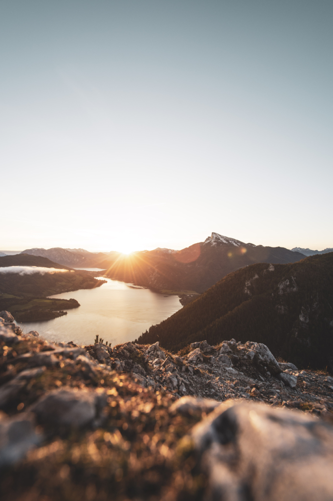 Sonnenaufgang am Gipfel der Drachenwand und Blick auf den Mondsee. Mit einer Höhe von 1176 hm liegt sie in den Salzkammergut-Bergen, einer Berggruppe in den Nördlichen Kalkalpen in Salzburg an der Grenze zu Öberösterreich, Österreich.